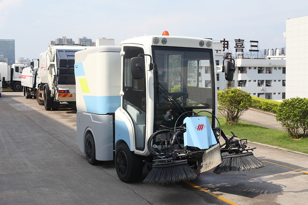 Performance and structural characteristics of FULONGMA intelligent electric road sweeper  FULONGMA Intelligent Electric Road Sweeper is an automatic cleaning integrated machine that combines road dust collection, sweeping, water spraying, and garbage transportation. It is a new type of cleaning equipment used in outdoor environments. The intelligent electric road sweeper is suitable for outdoor cleaning in parks, sanitation, cleaning companies, property management companies, squares, universities, highways, squares, etc.  01. Picture of Smart Electric Road Sweeper  02. Performance characteristics of intelligent electric road sweeper  1. Electric operation, no noise, no exhaust gas emissions, clean and environmentally friendly.  2. Small size, flexible turning, easy to drive, convenient maintenance, suitable for most manual cleaning places.  3. Integrate sweeping and suction, no secondary pollution, no secondary dust.  4. The cleaning effect is good, as small as dust and sand, as large as stones, broken bricks, leaves, and cigarette cases, it can be cleaned in one go.  5. Mechanized operation is not only efficient and effective, and the machine is clean wherever it goes, but also avoids the phenomenon of flying dust, difficult dust, and missed sweeping in manual cleaning.  03. Structural characteristics of intelligent electric road sweeper  1. Concise and clear operation interface, suitable for people of all ages to operate.  2. Adopt high-performance maintenance-free battery, no leakage, no harmful gas.  3. Humanized design, equipped with fan. The powerful fan has strong suction power and good sweeping effect. Through the reasonable design of the hydraulic system, the effect of automatically dumping the garbage in the trash can is achieved, thereby greatly reducing the labor intensity of the operator.  4. With cleaning and throwing technology, the theoretical value of the dust box utilization rate is high.  5. Well-known brand parts provide a good foundation for the stable performance of the product.  6. Solid tires, sturdy and durable.  7. Intelligent electronic control system, over-current, under-voltage protection, aggravated chassis, large garbage bin volume.  03. Video of Smart Electric Road Sweeper