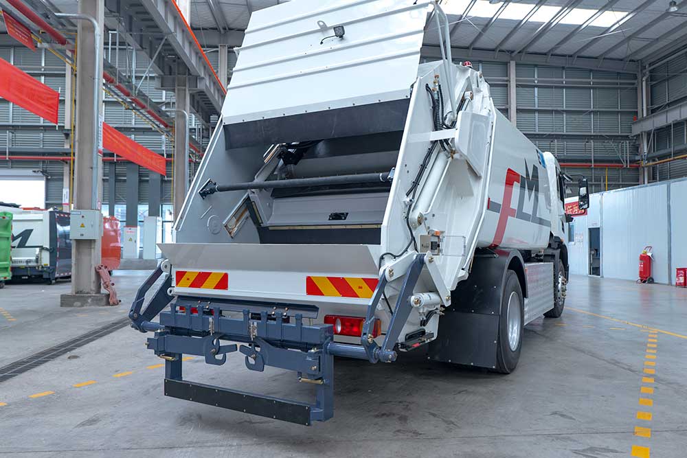 What is the difference between a side loader and a rear loader garbage truck?