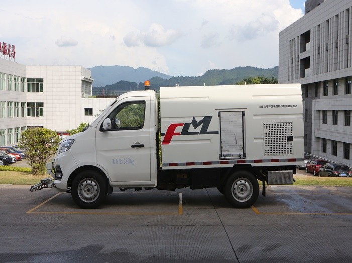 A road maintenance truck removes stubborn pavement contamination by combining concentrated water pressure