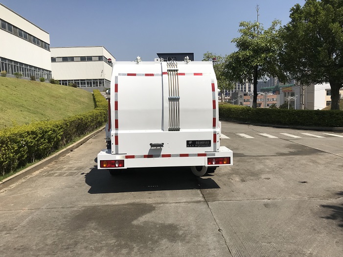 Rear-side view of a wet waste collection truck showing the sealed tank and unloading structure