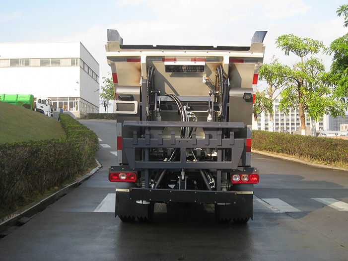 Rear view of a white self-loading garbage truck showing the specialized hydraulic bin-lifting mechanism and compact garbage container. (2)